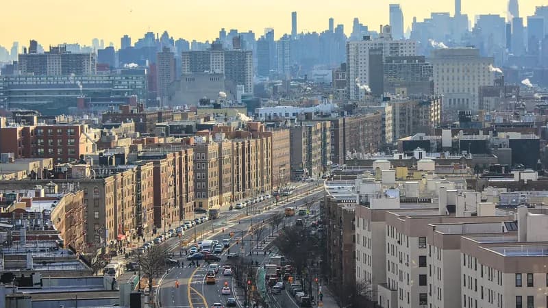 Apartment buildings along the Grand Concourse in the Bronx, seen from above and looking south toward the Manhattan skyline.