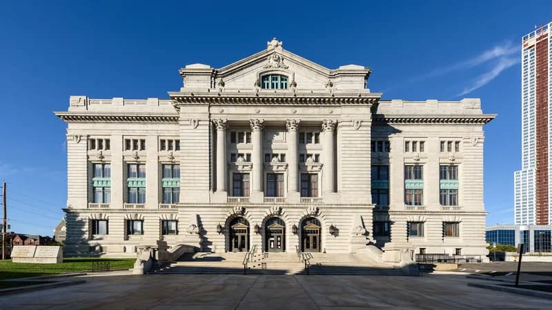 The white granite facade and entrance steps of the Hudson County Courthouse in Jersey City, New Jersey.
