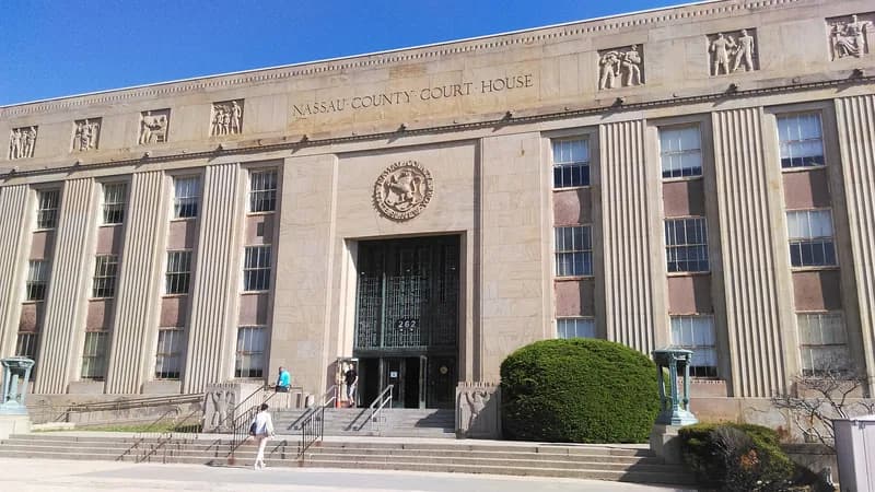 The limestone Nassau County Court House at 262 Old Country Road in Mineola, with its carved frieze and entrance steps.