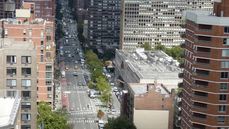 Second Avenue in Manhattan seen from above, with traffic, crosswalks and a bike lane running north between apartment towers.
