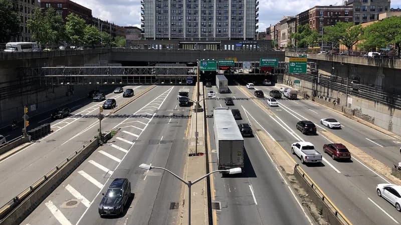 Traffic, including a tractor-trailer, on the Trans-Manhattan Expressway below the Amsterdam Avenue overpass in Washington Heights.