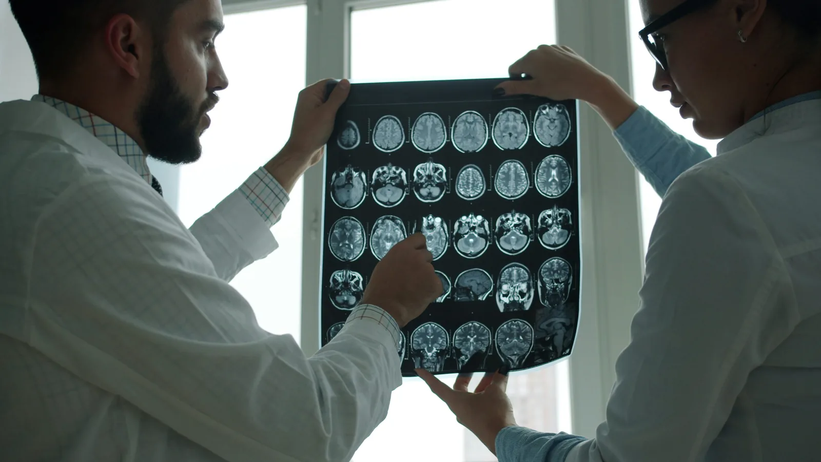 Doctors reviewing brain scans for a traumatic brain injury legal claim