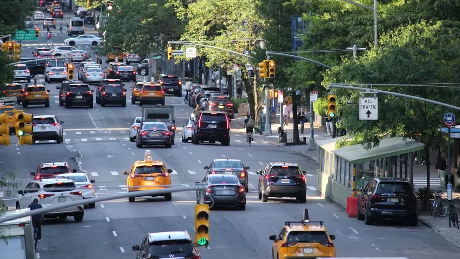 Cyclist riding through a New York intersection where lane markings, cameras, and traffic patterns can become evidence after a crash