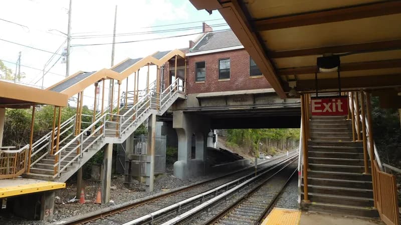 Stairs and a covered pedestrian overpass above the tracks at the Annadale Staten Island Railway station, seen from the platform.