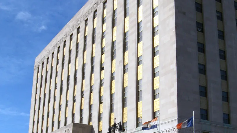 The limestone Bronx County Building on the Grand Concourse, with its carved frieze and the Bronx and New York City flags.