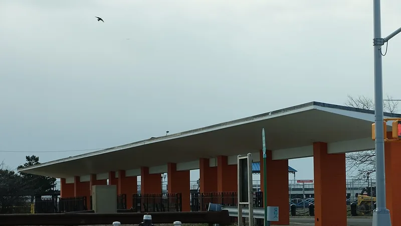 An orange-columned bus shelter beside Father Capodanno Boulevard in South Beach, Staten Island.