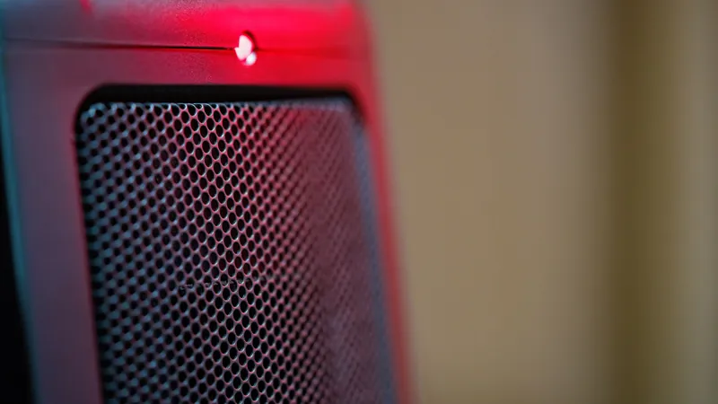 Close-up of a portable electric space heater glowing red, the kind of stopgap tenants turn to when building heat fails.