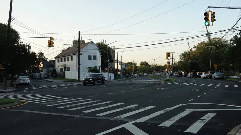 Wide crosswalks and traffic signals at Father Capodanno Boulevard and Ocean Avenue in South Beach, Staten Island.