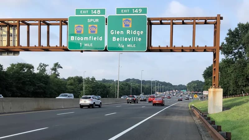 Traffic on the Garden State Parkway in Bloomfield, New Jersey, under exit signs for Bloomfield and Belleville.