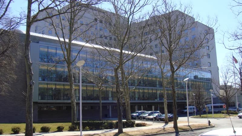 The glass-fronted ambulatory building at Jacobi Medical Center in the Bronx, behind bare trees and a parking lot.