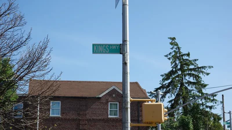 A green Kings Highway street sign at East 38th Street in Brooklyn.