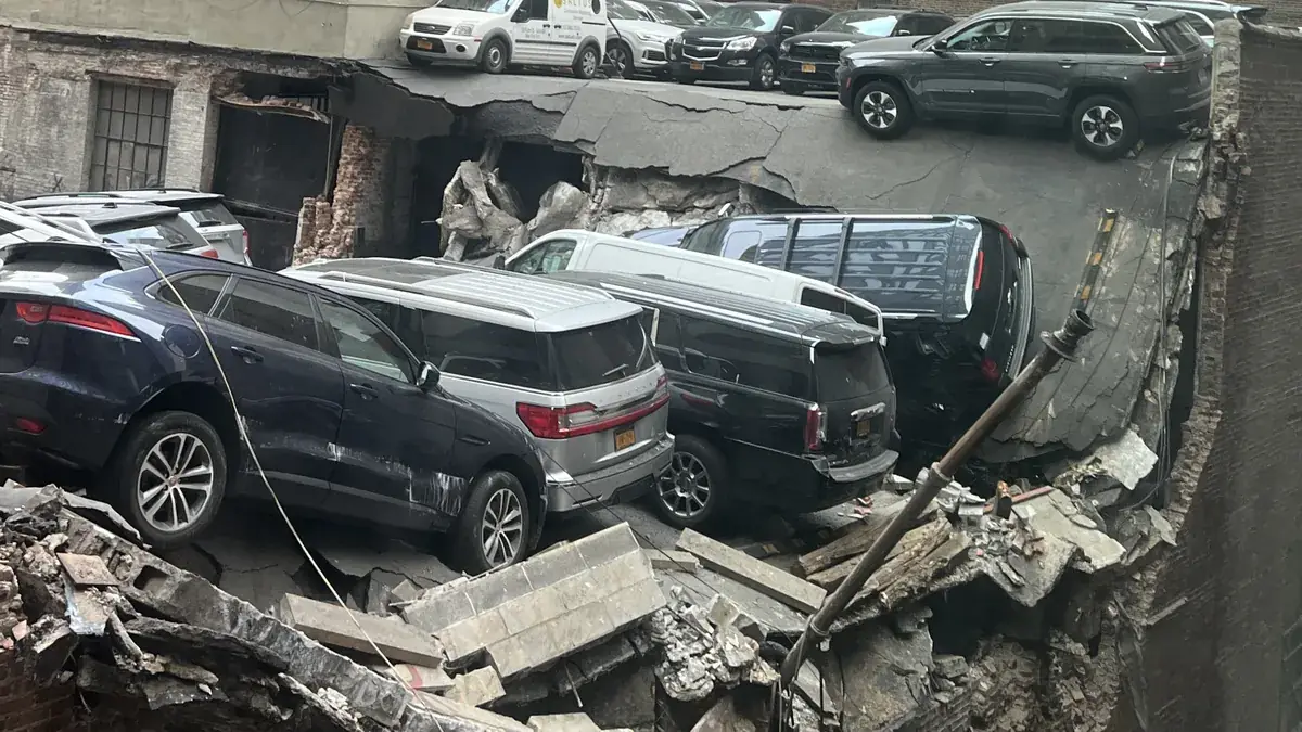 Collapsed upper decks and damaged cars inside the Ann Street parking garage in Lower Manhattan the day after its April 2023 collapse.