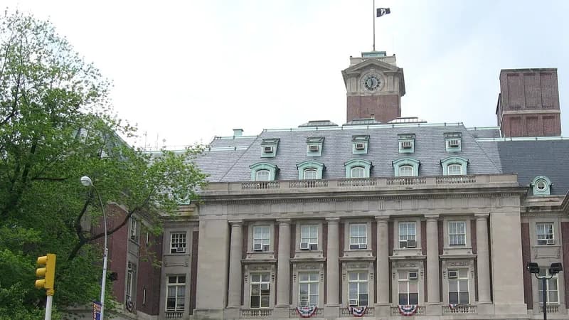 Staten Island Borough Hall in St. George, a stone and brick building with a clock tower and mansard roof.