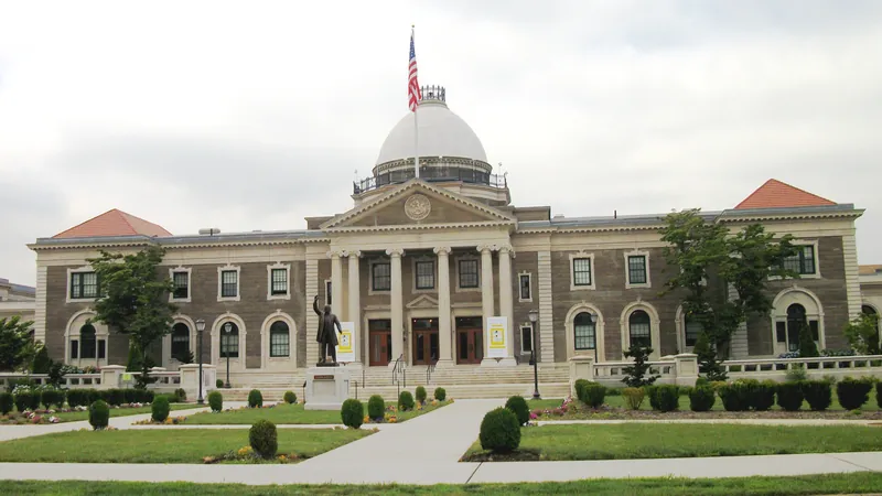 The domed Theodore Roosevelt Executive and Legislative Building, seat of Nassau County government, with its lawn and statue in Mineola.