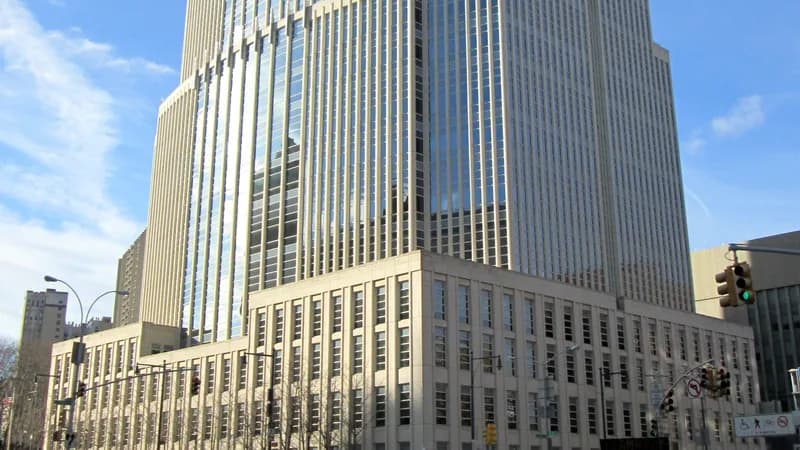 The Theodore Roosevelt United States Courthouse on Cadman Plaza East in Brooklyn under a blue sky.