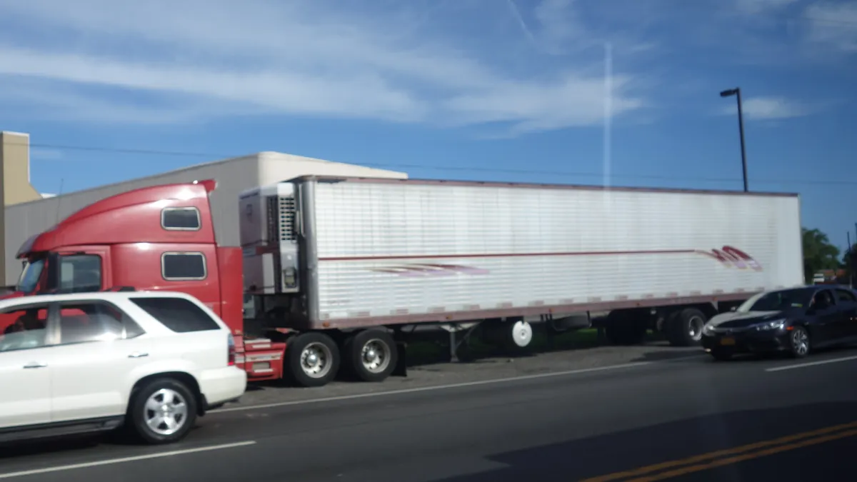 A tractor-trailer traveling beside passenger cars on the Nassau Expressway in Inwood, Long Island.