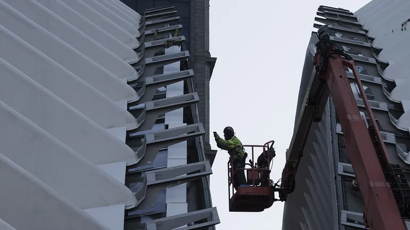 A worker on an aerial lift platform inspecting the steel ribs of the Oculus roof in Lower Manhattan.